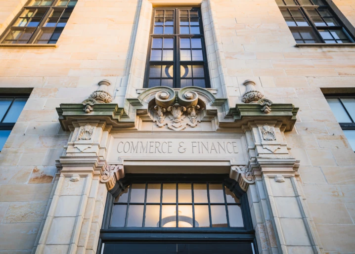 View looking up at the stone exterior of the Commerce and Finance Building on McNichols Campus.